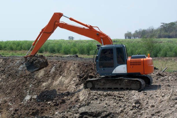Excavators are working to build ponds for agriculture in rural area.